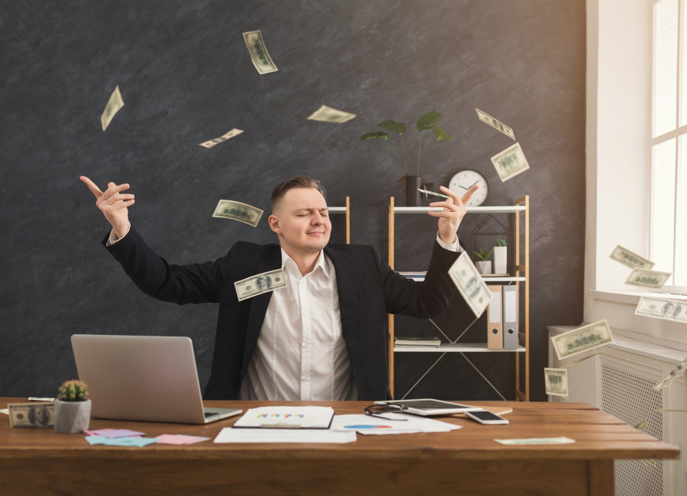 happy-financier-man-sitting-office-holding-dollars-man-throwing-out-money-copy-space_591.jpg